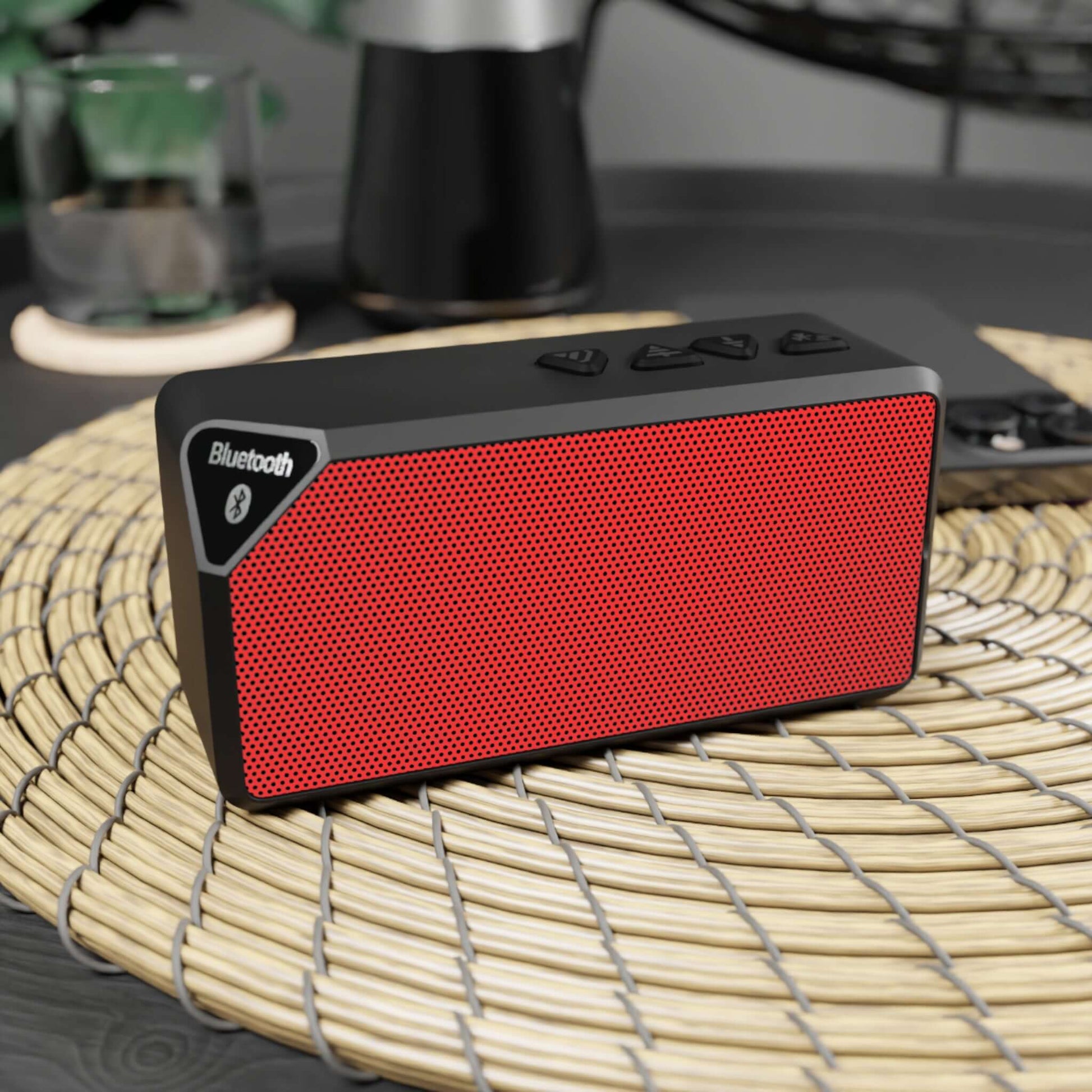 Red Bluetooth speaker with durable design, ideal for holiday vibes, featuring 33-foot range and two-hour playback.