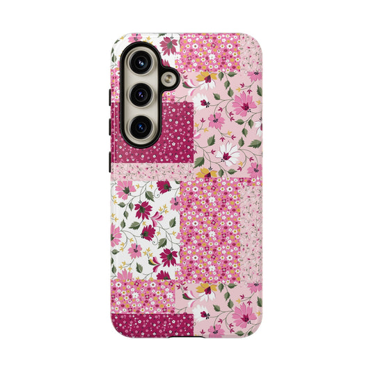 Cute floral patchwork phone case for iPhone 14 with pink blossoms and flowers, offering colorful protection and style.