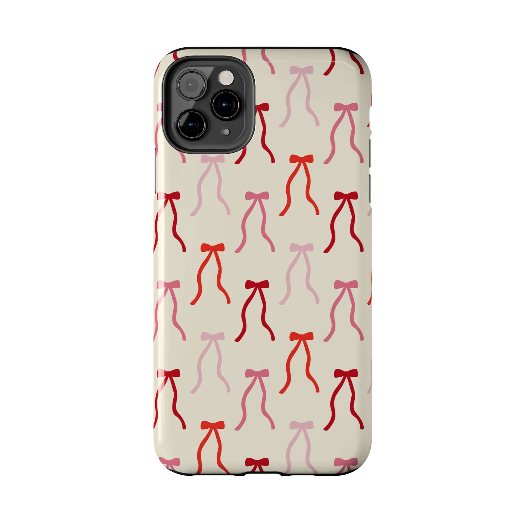 Cute beige phone case for iPhone 16 with red and pink coquette bow design, playful and stylish protection.