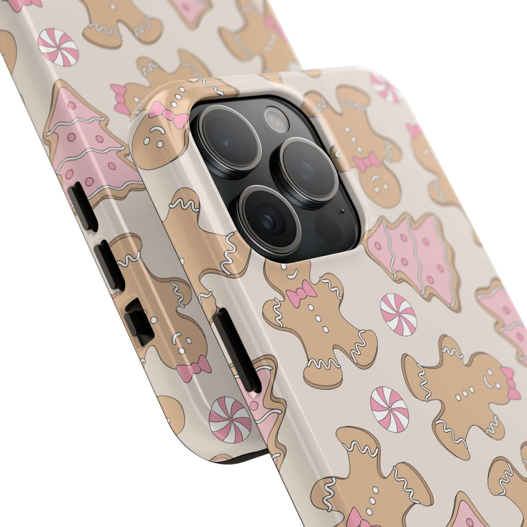 Cute gingerbread-themed iPhone case with festive holiday design, featuring colorful gingerbread cookies and pink accents, perfect for Christmas.