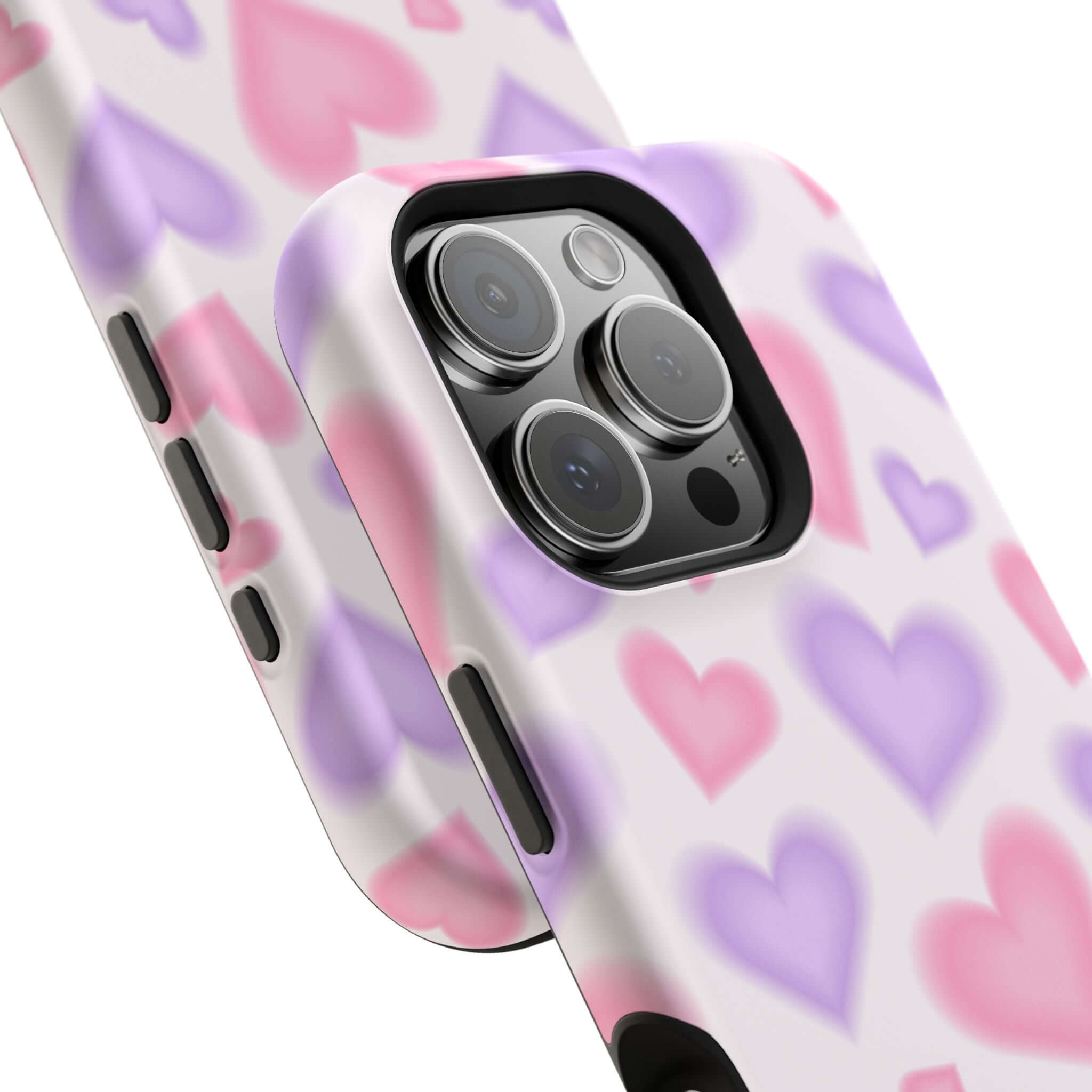 Cute pink and purple heart-patterned iPhone case showcasing MagSafe technology for stylish phone protection.