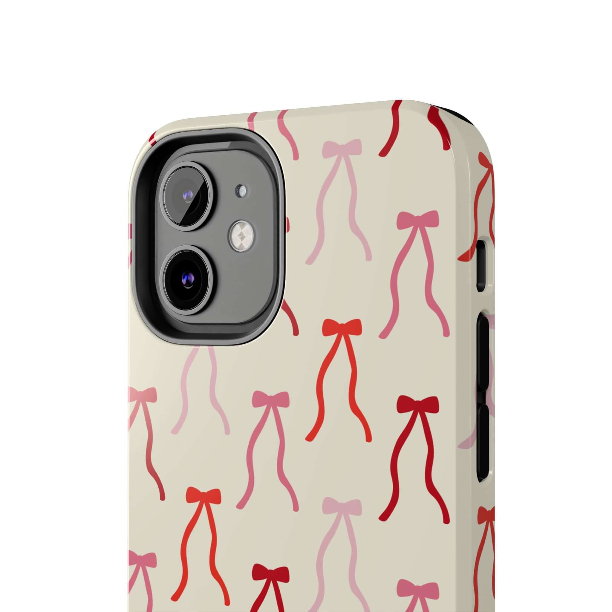 Beige coquette phone case with red bows, designed for iPhone 16. Cute and playful accessory for stylish phone protection.