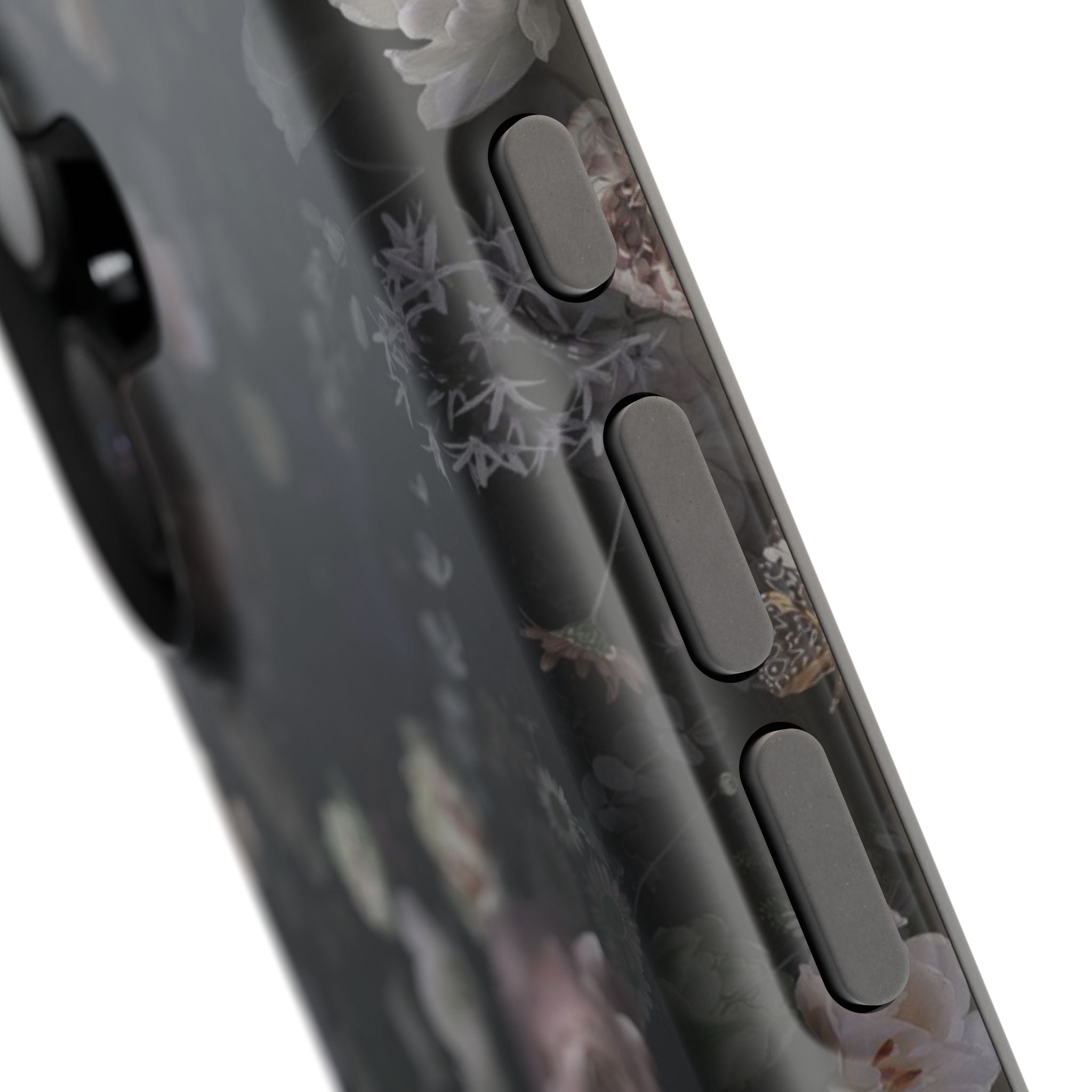 Close-up of Midnight Curse black floral MagSafe iPhone case, showcasing subtle floral design with button detail. Cute phone cover.