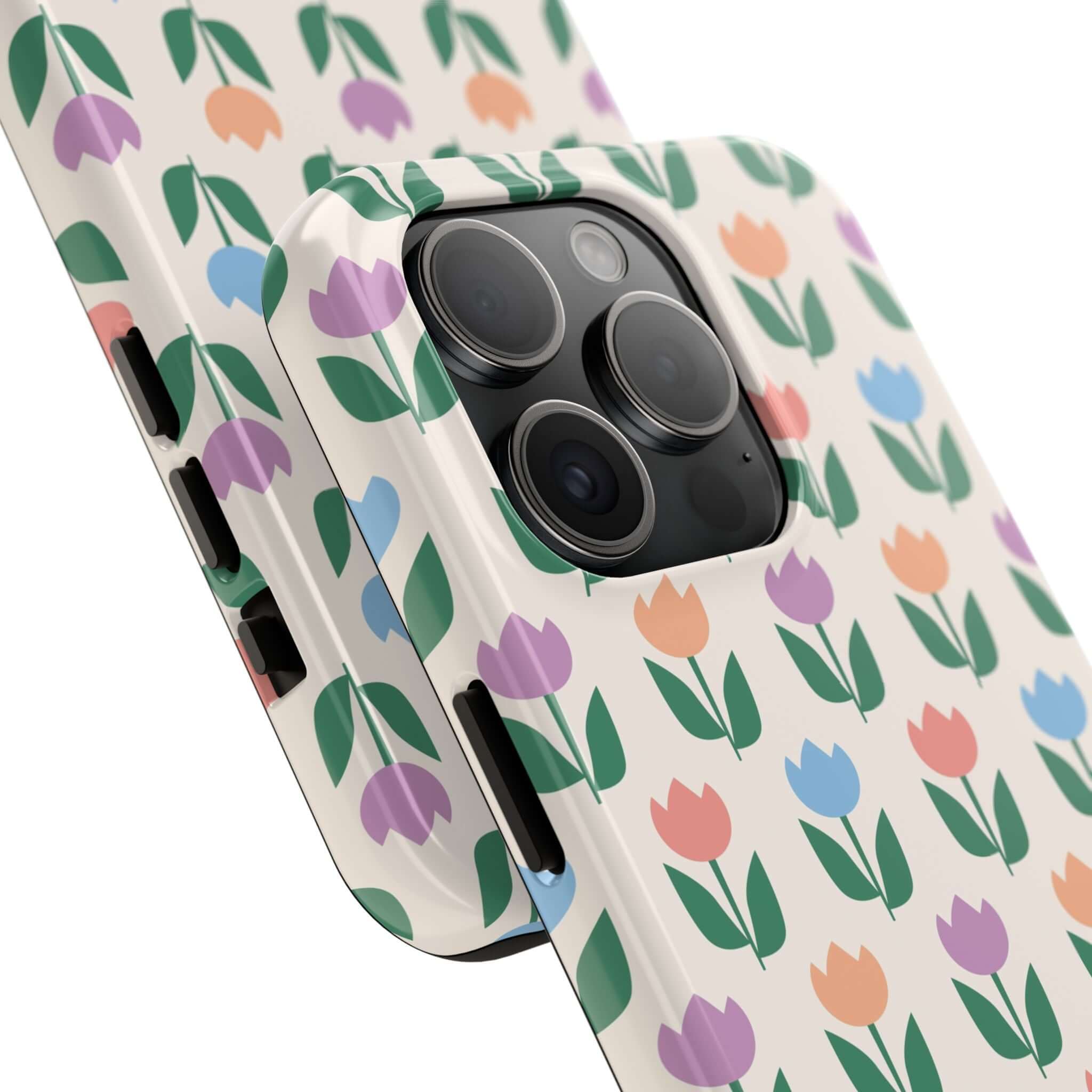 iPhone 14 Pro Max with vibrant tulip floral phone case, colorful flowers on white background.